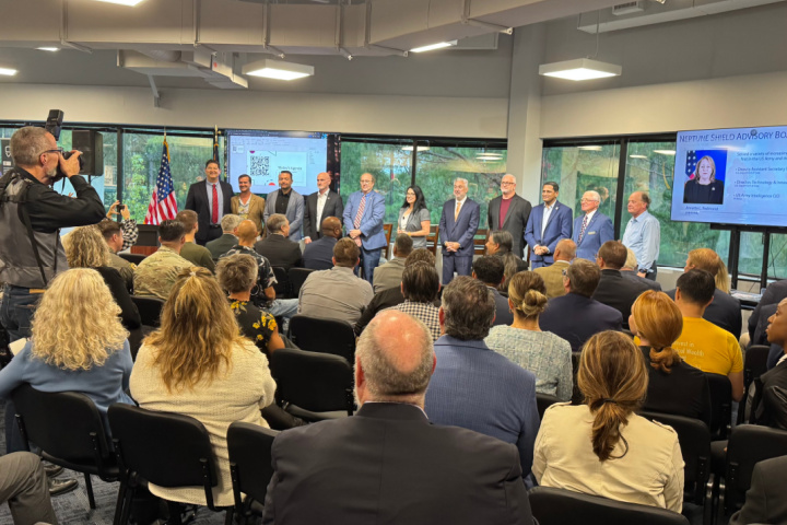 Neptune Shield leaders and community members gather for a ribbon cutting event in Hampton Roads, marking the opening of the veteran-focused business incubator and accelerator space.